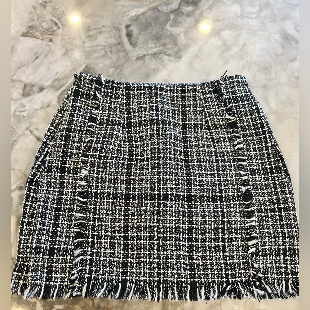 Mini woven skirt with fringe. Never worn. Thick but comfortable material.